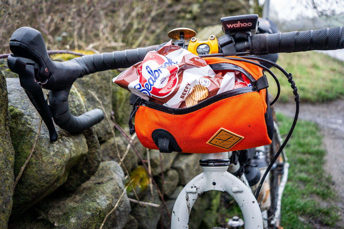 restrap canister bag with food hanging out of it, demonstrating how much can fit into the bag