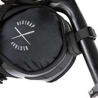 closeup of Black race saddle bag attached to a bike frame on a white background