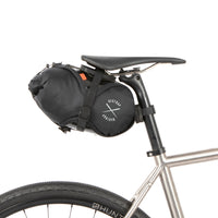 Black race saddle bag attached to a bike frame on a white background