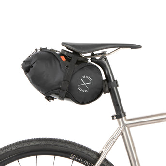 Black race saddle bag attached to a bike frame on a white background