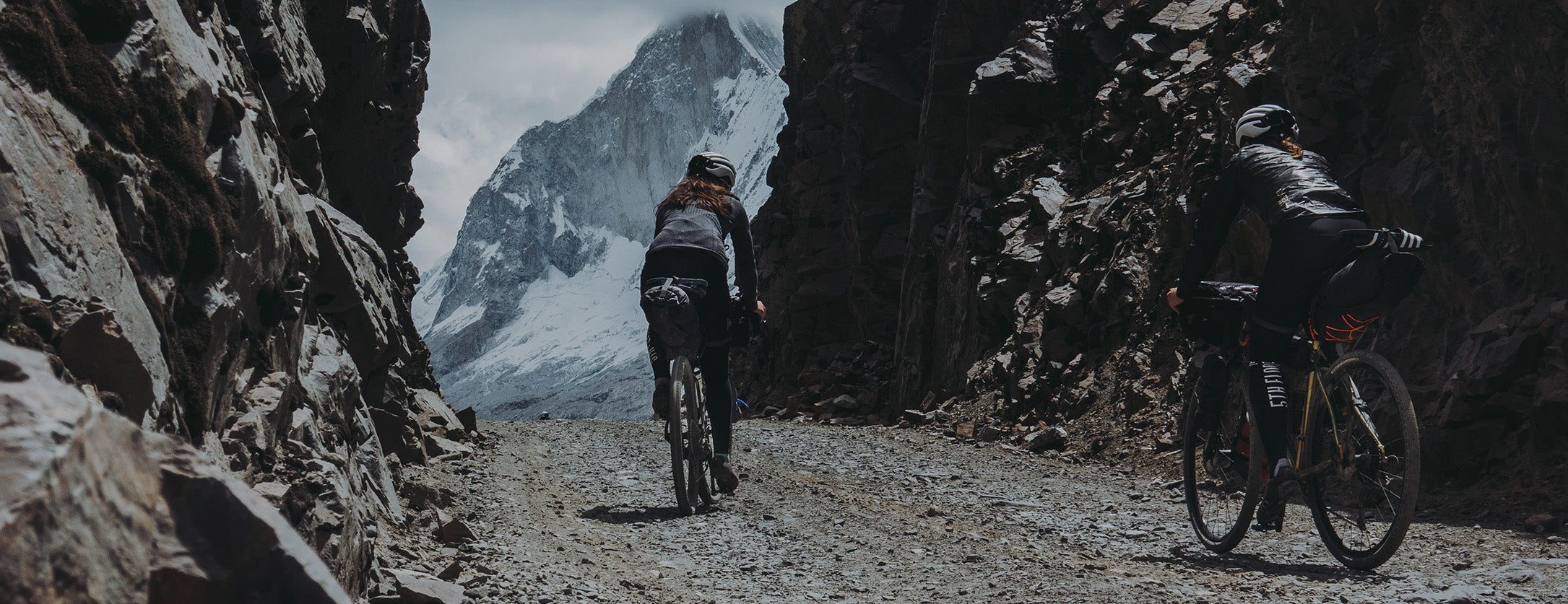 two riders heading over a mountain pass with restrap bikepacking bags attached