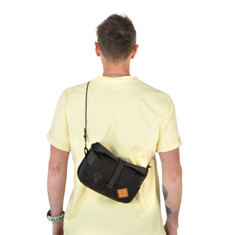 A black Rolltop Canister Bag attached to the handlebars of a bicycle, featuring a waterproof design with a capacity of 4L and a Fidlock buckle.