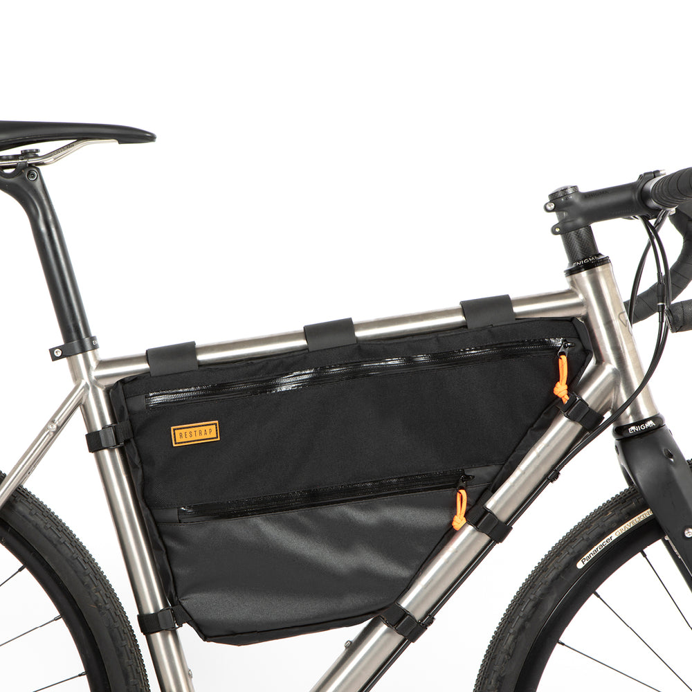 A black Restrap Full Frame Bag mounted on the down tube of a bicycle, featuring adjustable straps and the Restrap brand label.