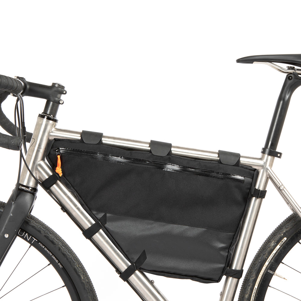 A black Restrap Full Frame Bag mounted on the down tube of a bicycle, featuring adjustable straps and the Restrap brand label from the non drive side