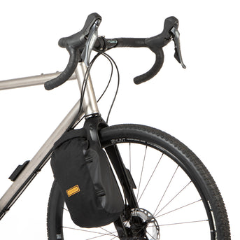 Restrap Switch Pannier bag attached to a bicycle fork with a visible brand logo.
