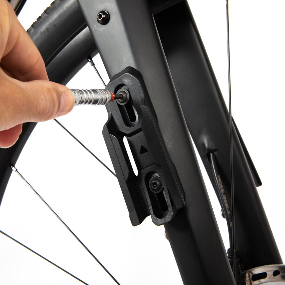 Person tightening the fittings of a restrap switch multi mount