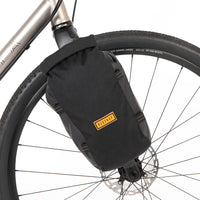 Restrap Switch Pannier bag attached to a bicycle fork with a visible brand logo.