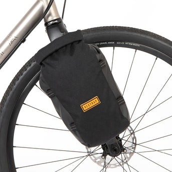 Restrap Switch Pannier bag attached to a bicycle fork with a visible brand logo.