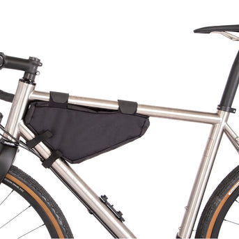A black Restrap frame bag small attached to the down tube of a bicycle, featuring a visible zipper and the brand's label.