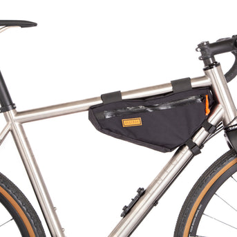 A black Restrap frame bag small attached to the down tube of a bicycle, featuring a visible zipper and the brand's label.