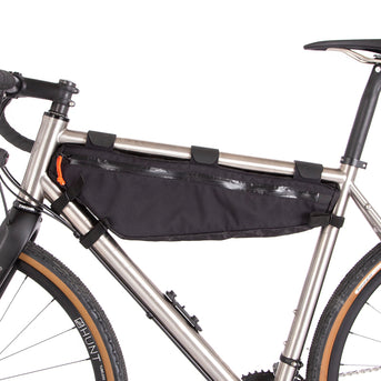 A large black Restrap frame bag attached to a bicycle frame, designed for carrying additional items while biking.