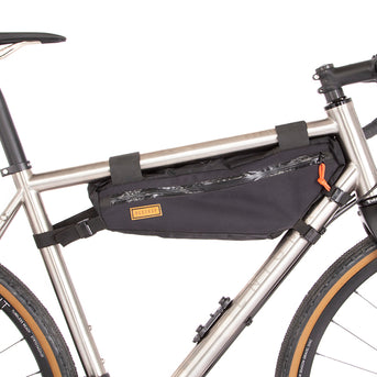 A black Restrap frame bag medium attached to the down tube of a bicycle, featuring a visible brand label and YKK zippers.