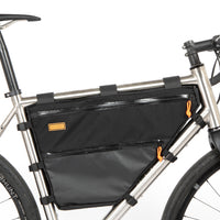 A large black full frame bag attached to a bicycle frame, with adjustable straps and a Restrap label visible.
