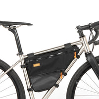 A small black full frame bag attached to the down tube of a bicycle, featuring adjustable straps, two zips and a Restrap label.