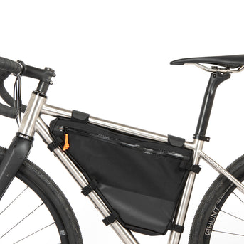 A small black full frame bag attached to the down tube of a bicycle, featuring adjustable straps, two zips and a Restrap label.