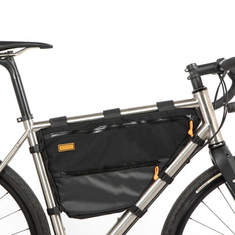 A black Restrap Full Frame Bag mounted on the down tube of a bicycle, featuring adjustable straps and the Restrap brand label.