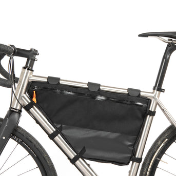 A black Restrap Full Frame Bag mounted on the down tube of a bicycle, featuring adjustable straps and the Restrap brand label.